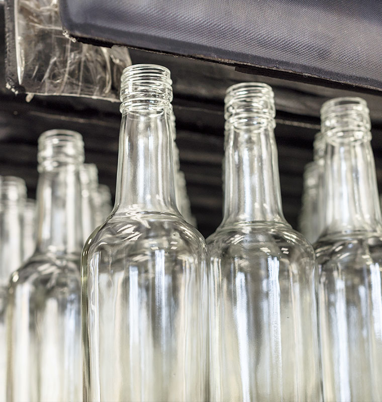 Close up of wine bottles with conveyer equipment